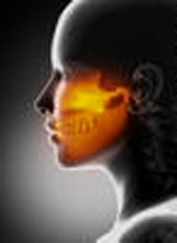 A woman 's face with an orange glow on it.